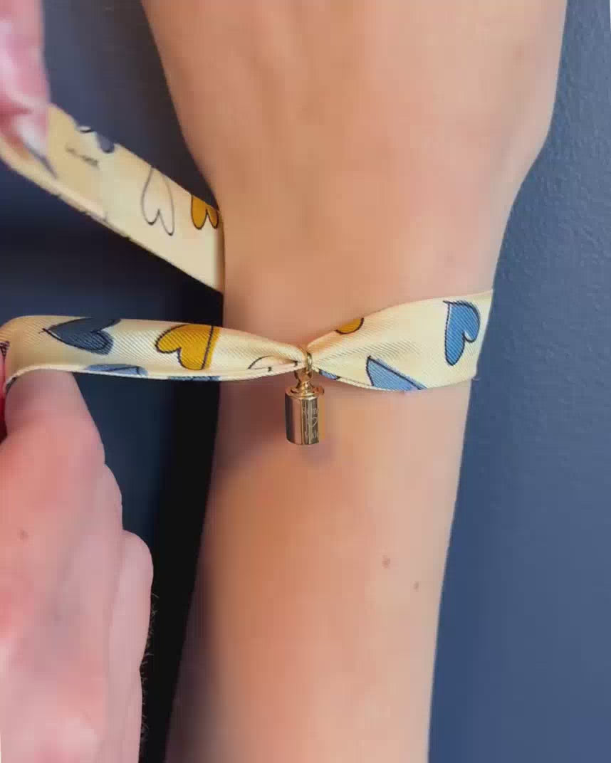 Vidéo du bracelet personnalisable Les Mots Bleus en plaqué or jaune avec ruban en soie – bijou personnalisé gravé pour femme.
